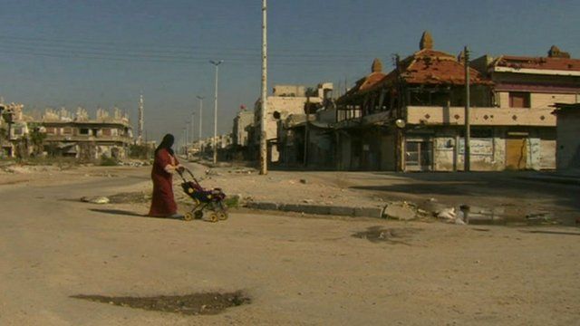 Woman walking in Baba Amr district of the central Syrian city of Homs