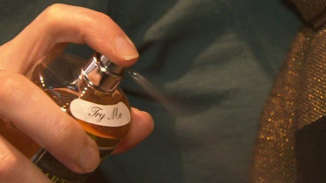 Woman sprays fragrance