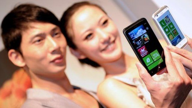 Models holding HTC phones