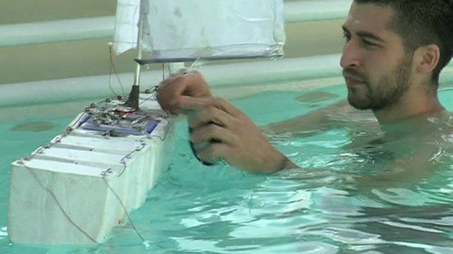 Man with toy boat in pool