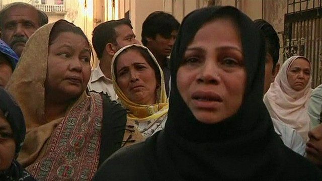 A woman speaking to reporters in the aftermath of the Karachi blast