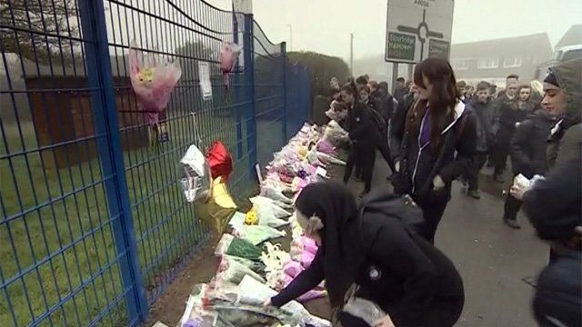 Flowers being laid outside Leasowes High School in Halesowen