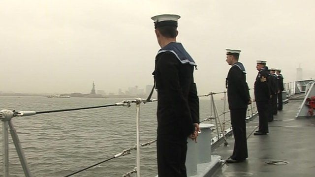 The crew of HMS Edinburgh on deck, with the Statue of Liberty visible in the distance