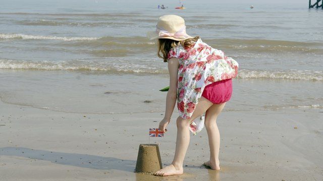 Girl builds sandcastle