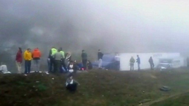 People standing on grass verge at accident scene