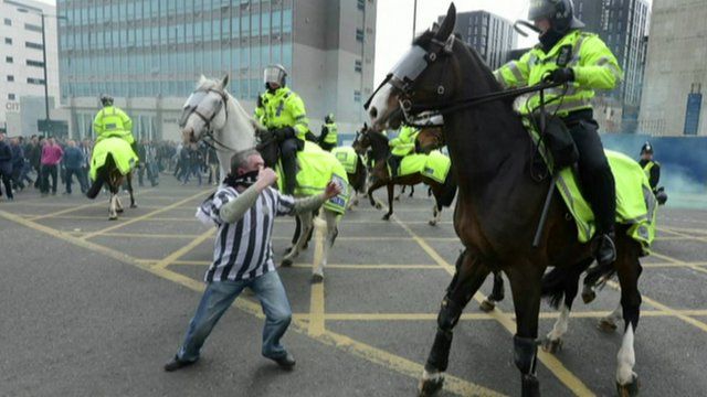 Football fan and policemen on horseback