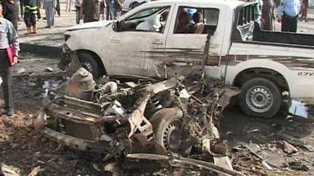Damaged vehicles in the aftermath of one of the blasts