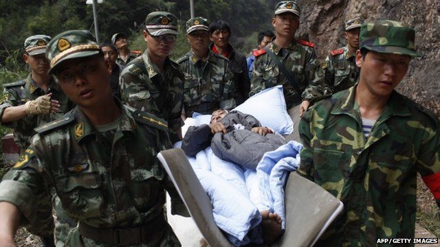 rescuers carrying an injured survivor to an emergency relief centre