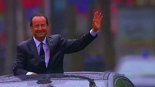 President Hollande waves from a car during his inauguration