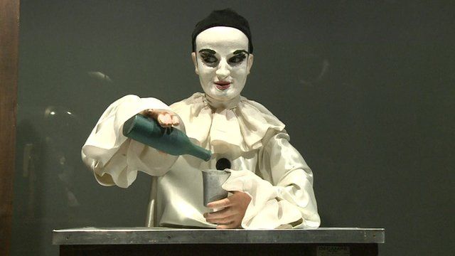 Robot figure pouring glass of wine