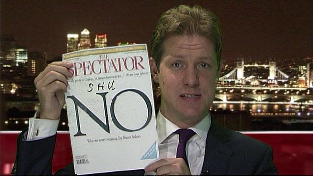 Fraser Nelson holds up the latest issue of the Spectator