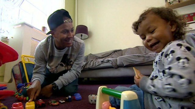 Anthony George plays with his son
