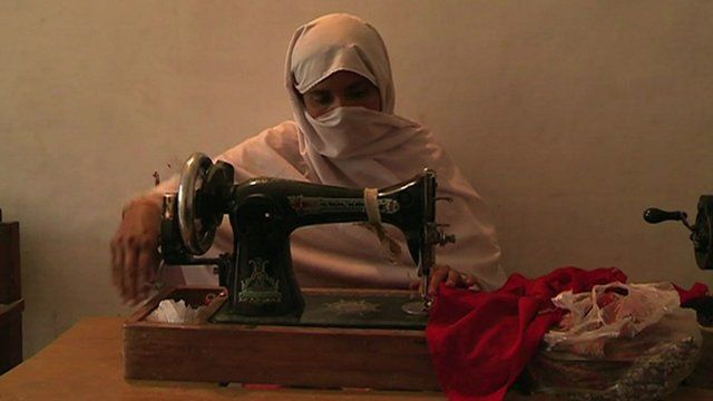 Meena sewing some clothes