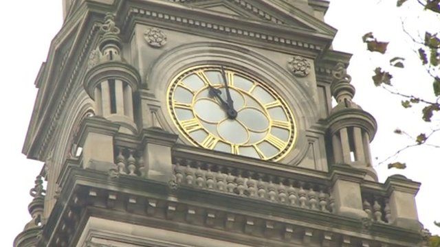 A clock strikes the eleventh hour on Armistice Day 2013