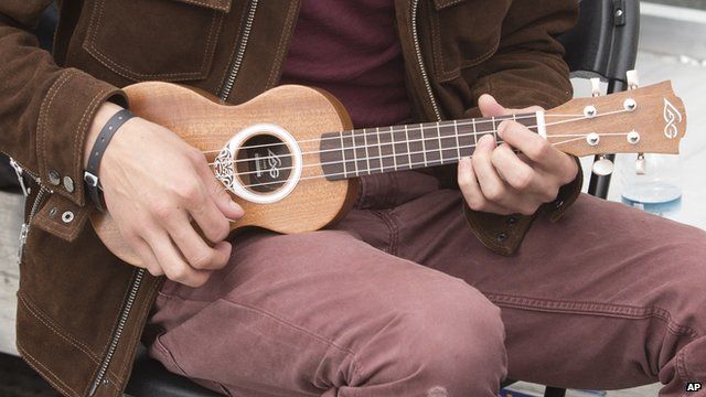 Boy playing a ukulele