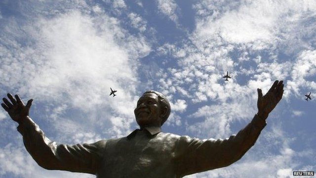 South African military jet fighters fly past a nine-metre (30ft) bronze statue of the late former South African President Nelson Mandela