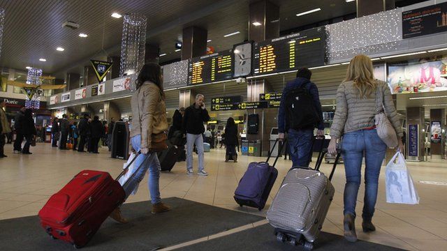 Romanians carry their luggage at Otopeni airport near Bucharest
