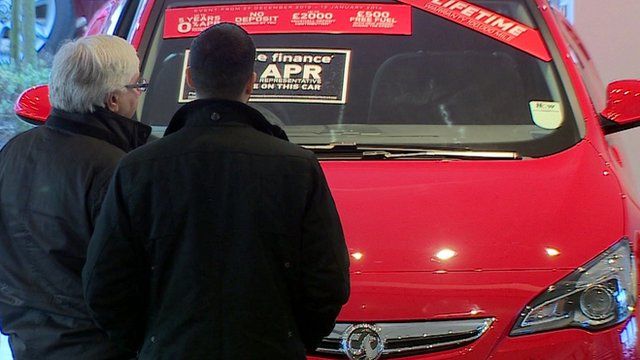 People viewing a car for sale