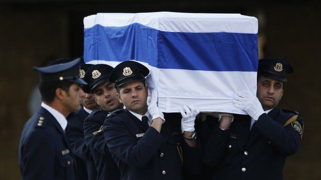 Members of the Knesset guard carry the coffin of Ariel Sharon
