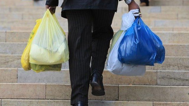 Man carrying plastic bags