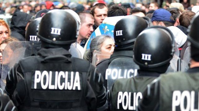 Bosnian citizens' rights activists argue with riot police