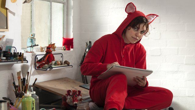Woman dressed in red animal onesie
