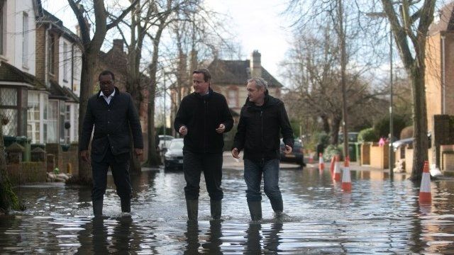 David Cameron walks through flood water during a visit to Staines-upon-Thames