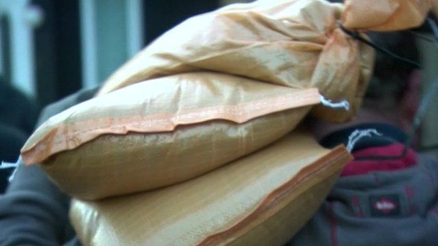 Man carrying sandbags on shoulder