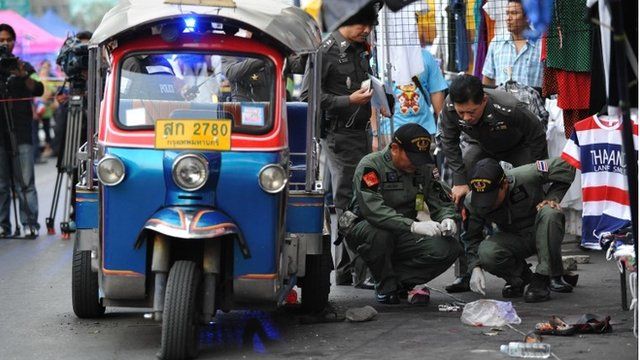 Bomb squad police examine the scene