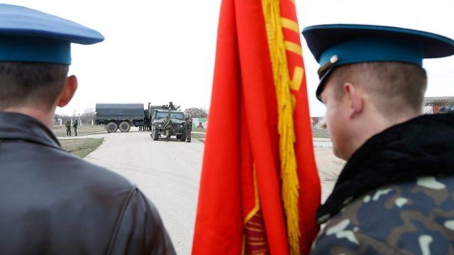 Ukrainian troops watch Russian soldiers carefully