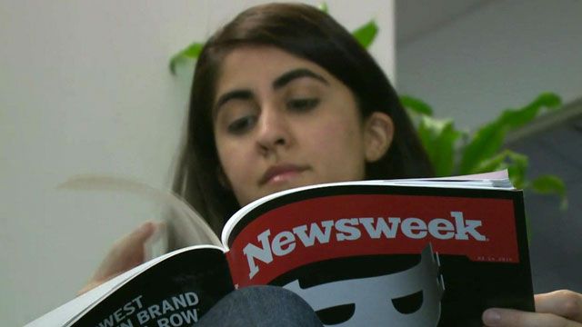 Woman reading new print edition of Newsweek