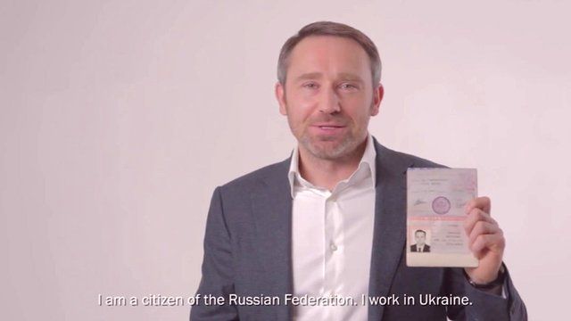 Man holding up Russian passport in YouTube video