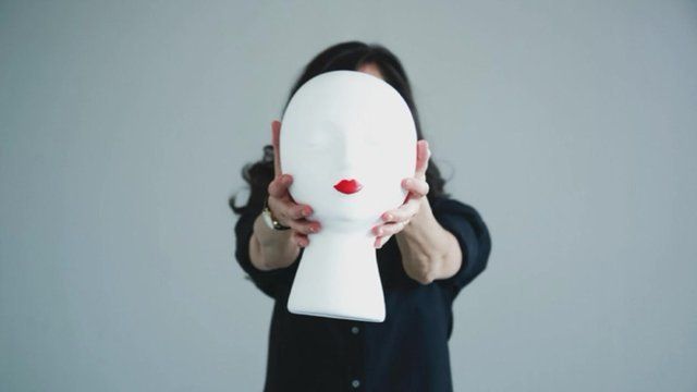 Leah Vincent holds up a 'wig head'