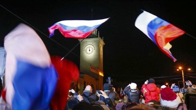 People celebrate the ceremonial change of time on the railway square in the Crimean city of Simferopol