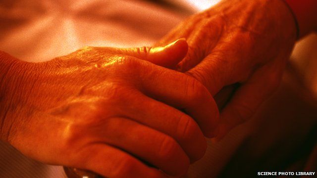 Elderly people holding hands
