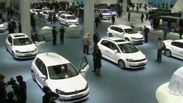 A number of cars on display