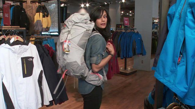 Sumi Das wears a backpack in a shop