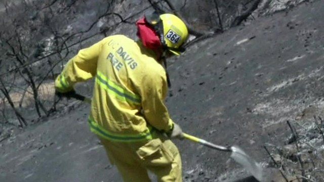 Firefighter clearing fire damage