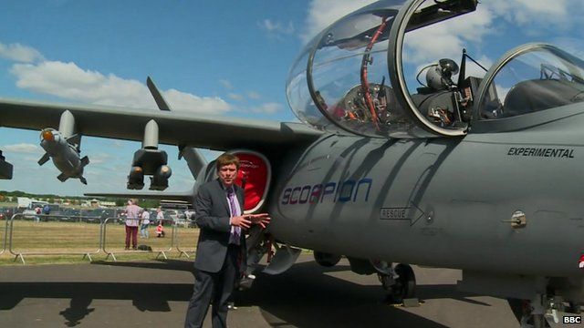 The BBC's Nigel Cassidy next to a Scorpion fighter jet at Farnborough Airshow