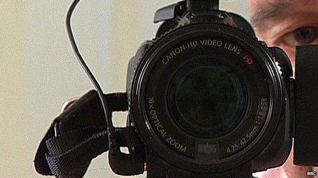 Man's face behind camera