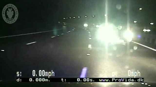 Still from dashboard camera shows car approaching police vehicle head on