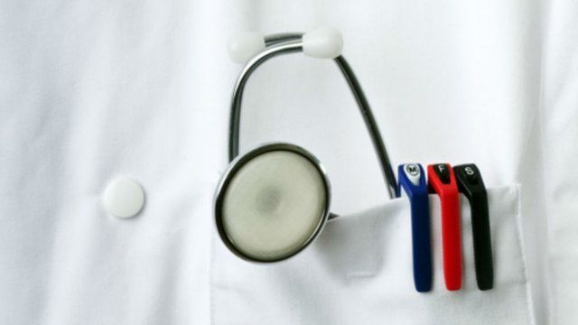 Doctor's coat pocket with stethoscope and pens