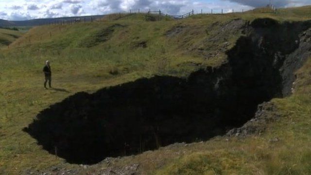 Landowner standing next to sink-hole