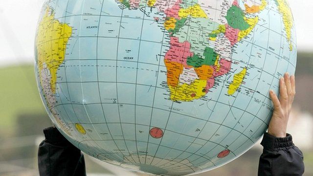 Person holding a blow-up globe
