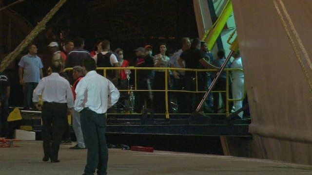 Syrian refugees disembark from a cruise ship