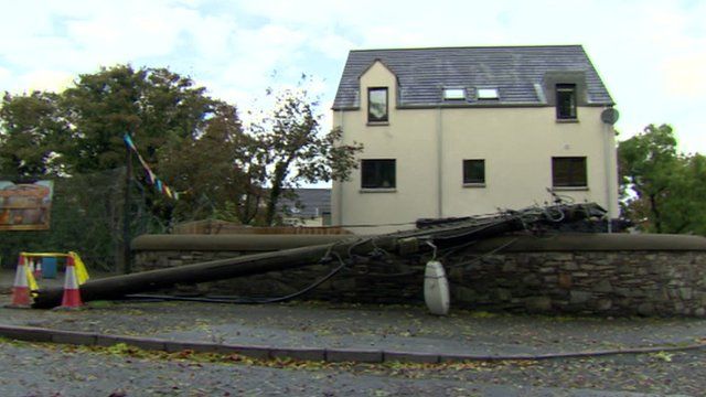 Fallen telegraph pole in front of a house