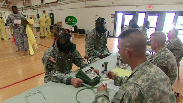 US troops being kitted out with gas masks and protective suits