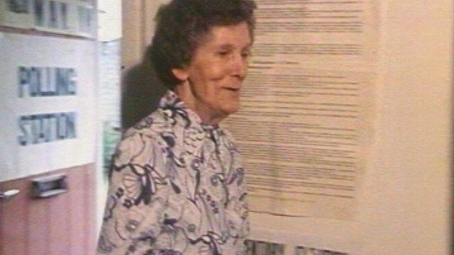 One of four voters in a polling station in Rhonnda casts her ballot