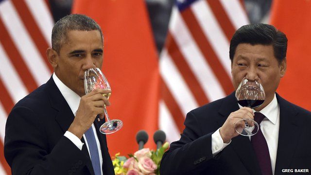 President Obama and China's President Xi drink a toast at a banquet in Beijing
