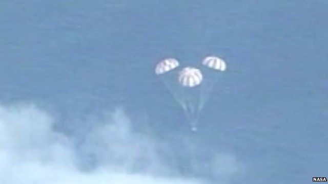 In this frame grab from NASA-TV, the Orion spacecraft descends before splashing down in the Pacific Ocean